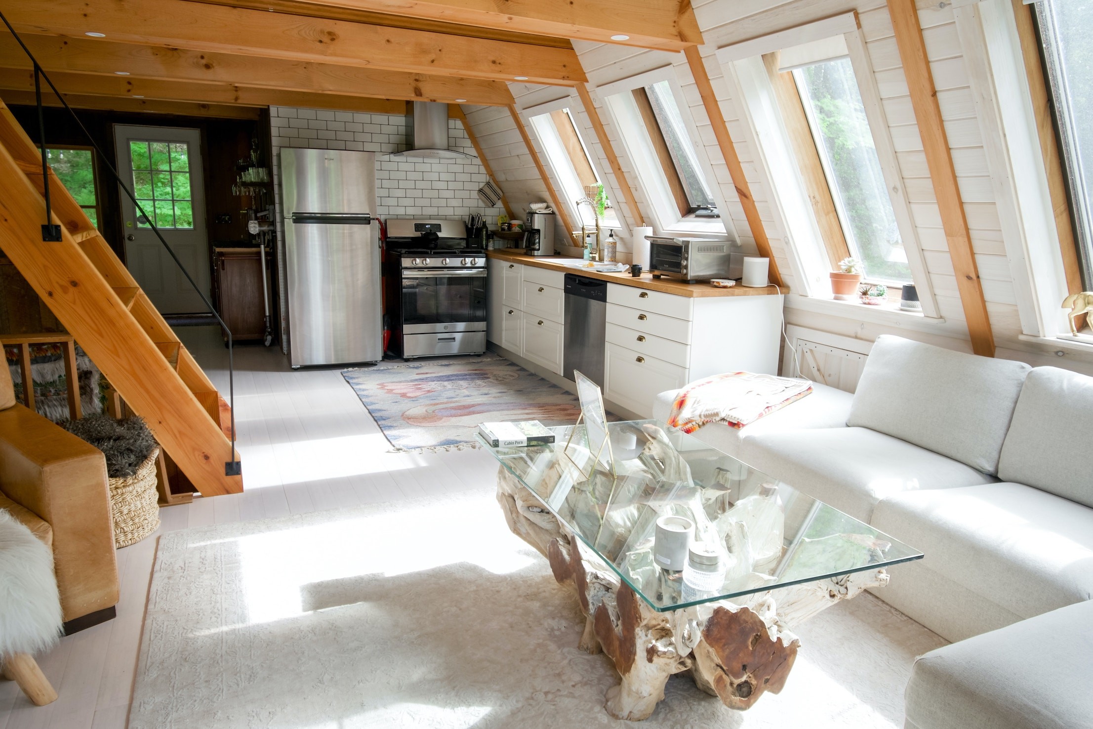 A cozy living room in an Airbnb tiny house with wooden beams, hosted by a superhost.