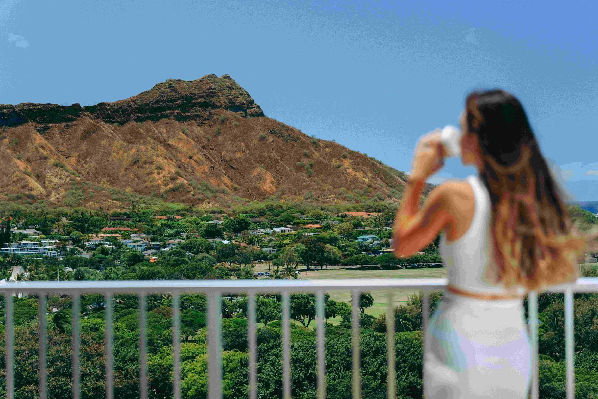 A Guest Enjoys the Breathtaking Mountain View From a Balcony