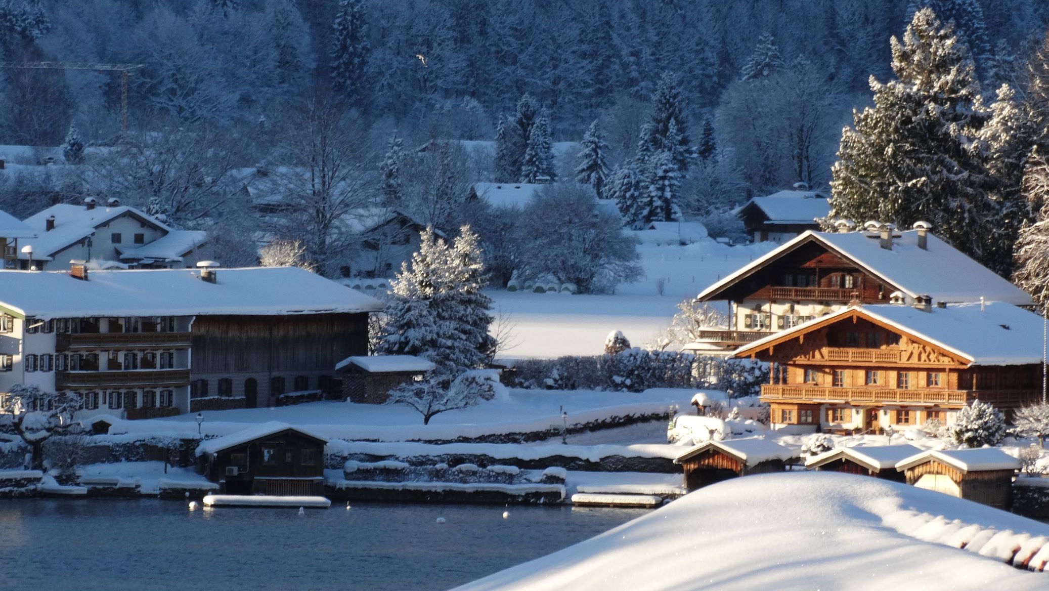 A Snow Covered Lake Adjacent to a Concierge Chalet