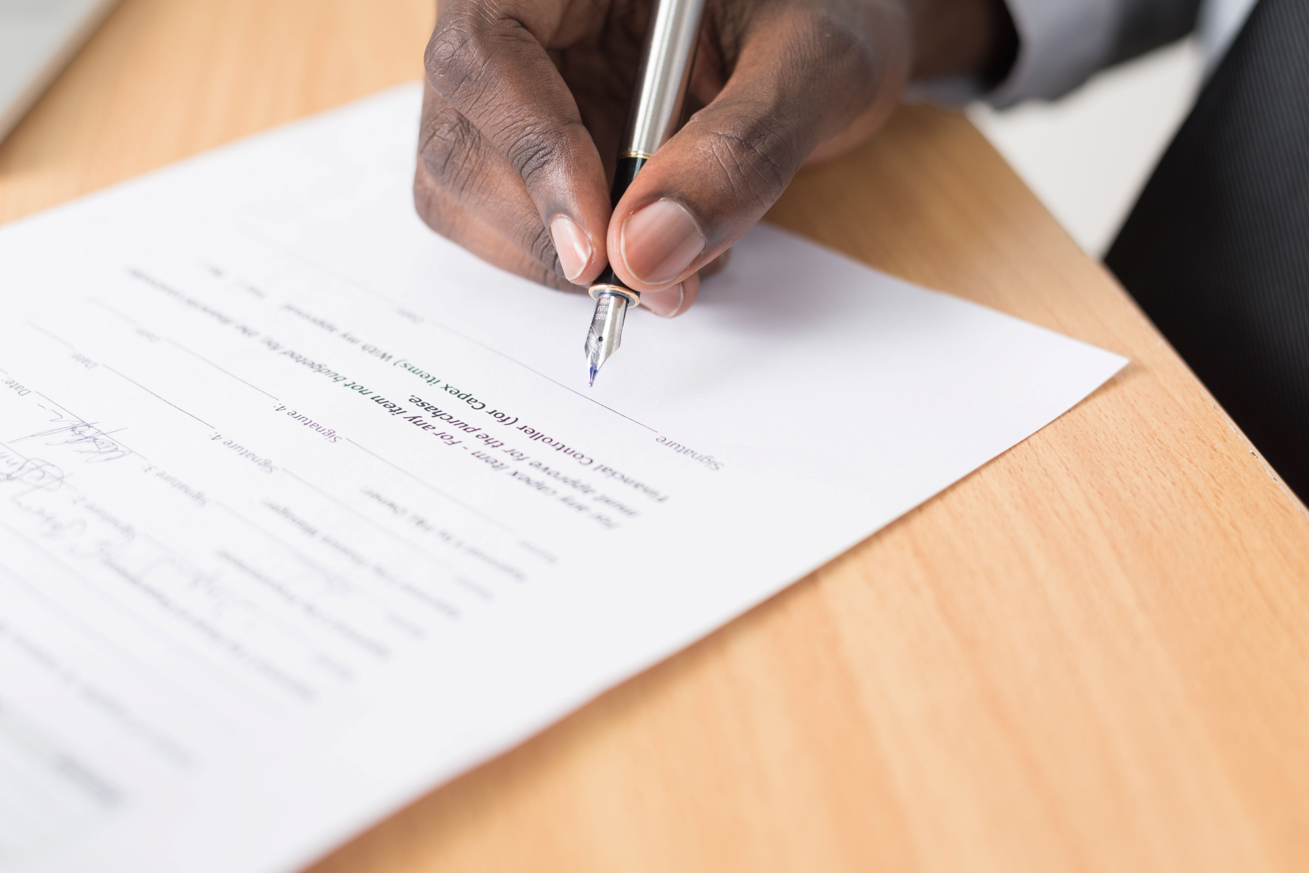 A Man Executing a Short Term Rental Agreement with a Pen